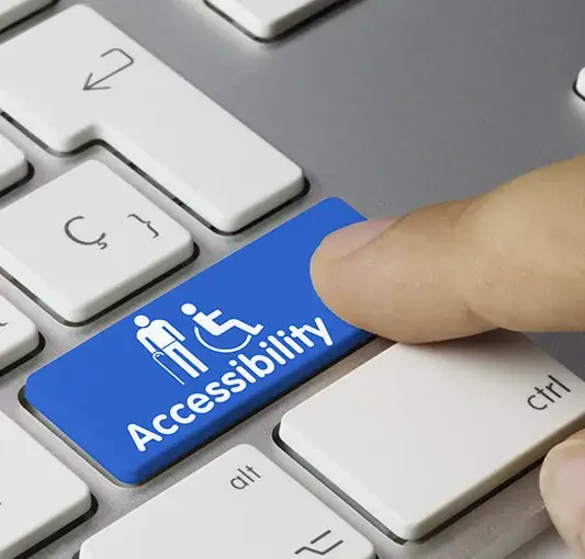 Keyboard with an accessibility key showing wheelchair and figure icons