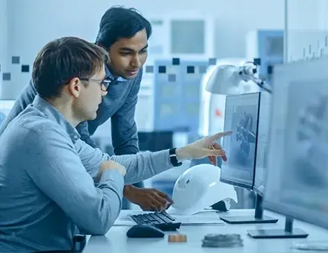 Engineers monitoring automated equipment on a production line